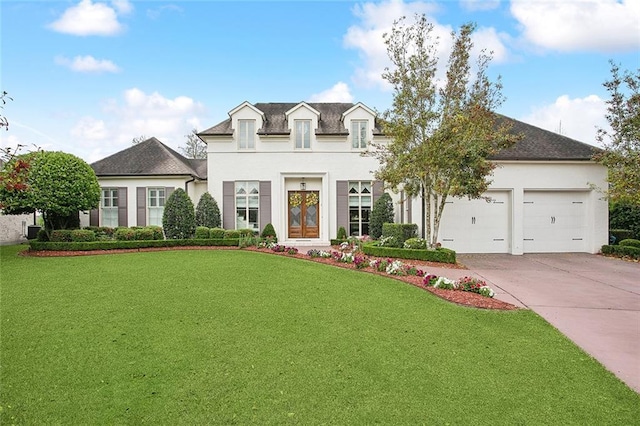 view of front of house with stucco siding, an attached garage, a front lawn, and concrete driveway