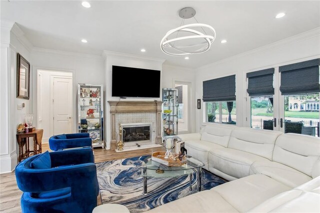 living room featuring recessed lighting, wood finished floors, and ornamental molding