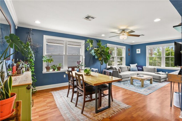 4634 Frenchmen St, New Orleans, LA 70122 - dining room featuring crown molding, baseboards, ceiling fan, light wood-style flooring, and visible vents