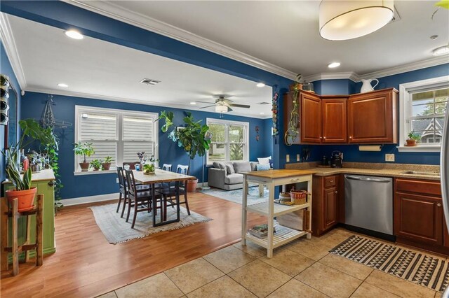 4634 Frenchmen St, New Orleans, LA 70122 - kitchen featuring visible vents, ornamental molding, ceiling fan, stainless steel dishwasher, and light tile patterned floors