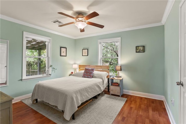 4634 Frenchmen St, New Orleans, LA 70122 - bedroom featuring wood finished floors, crown molding, baseboards, and visible vents