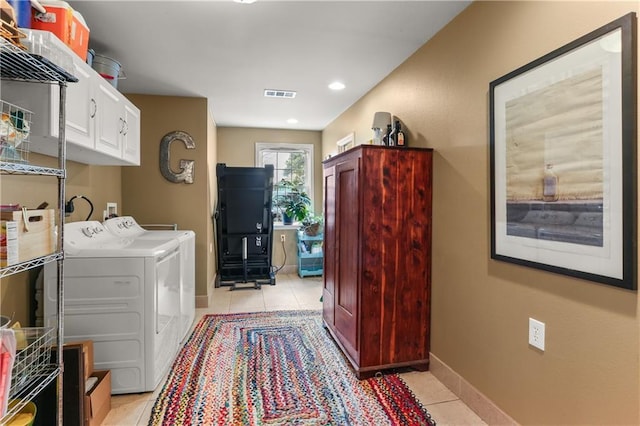 4634 Frenchmen St, New Orleans, LA 70122 - clothes washing area with light tile patterned floors, baseboards, visible vents, cabinet space, and washer and dryer