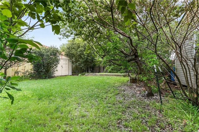 4634 Frenchmen St, New Orleans, LA 70122 - view of yard with an outdoor structure, a storage unit, and fence