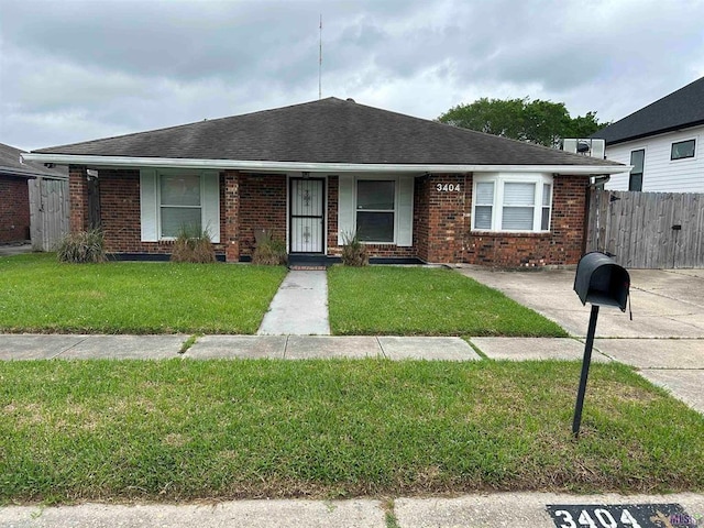 3404 Veronica Dr, Chalmette, LA 70043 - view of front facade featuring brick siding and roof with shingles