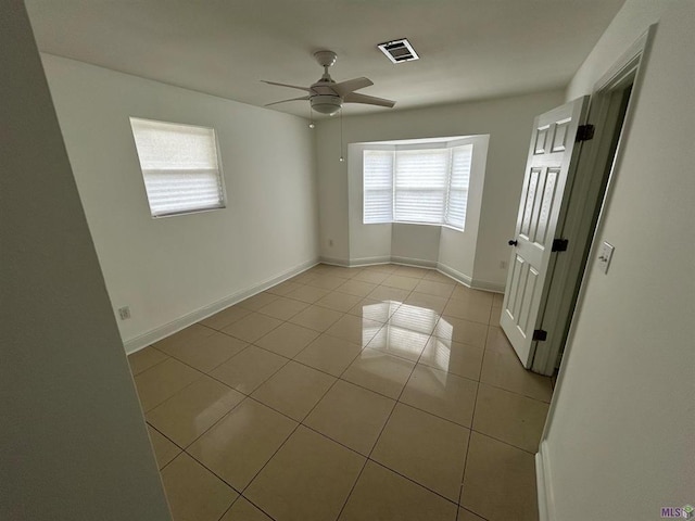 3404 Veronica Dr, Chalmette, LA 70043 - spare room featuring light tile patterned floors, a ceiling fan, and baseboards
