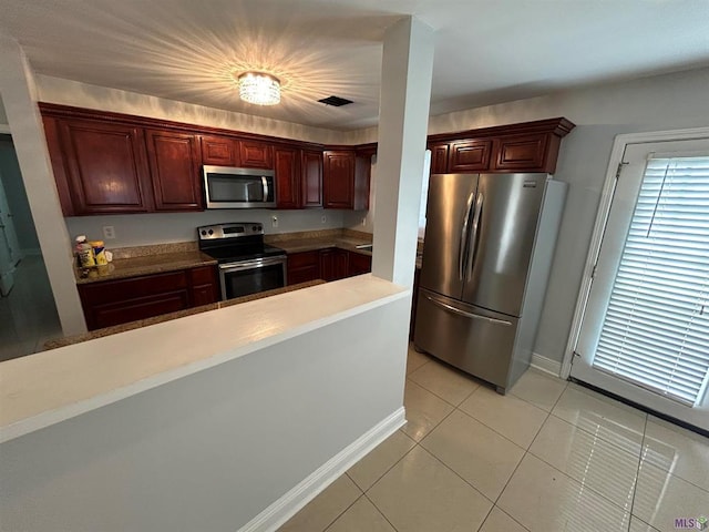 3404 Veronica Dr, Chalmette, LA 70043 - kitchen with stainless steel appliances, light tile patterned flooring, and baseboards