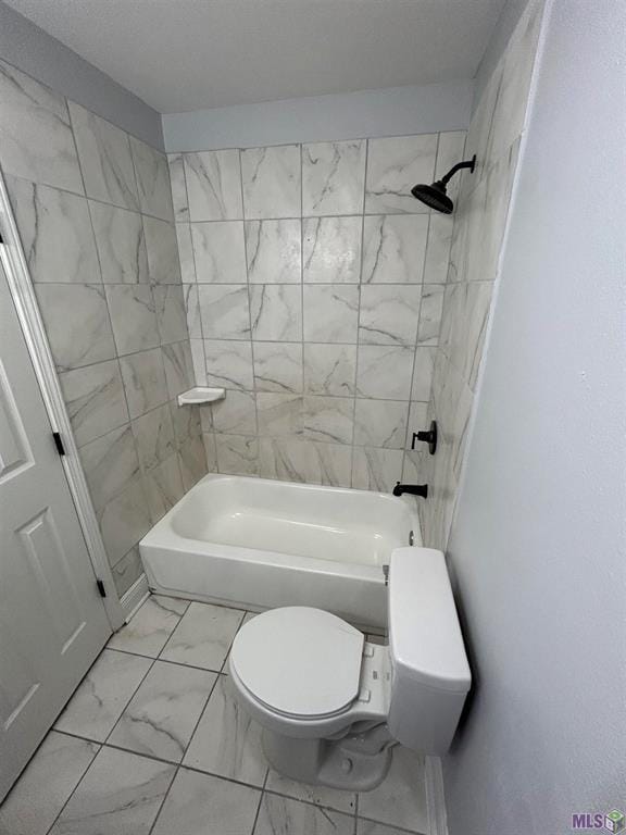 3404 Veronica Dr, Chalmette, LA 70043 - bathroom with marble look tile flooring, toilet, and bathtub / shower combination