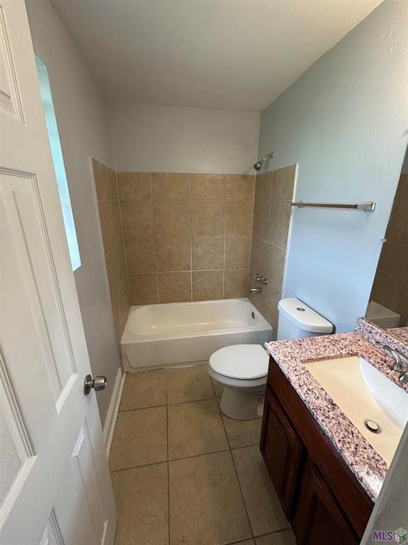 3404 Veronica Dr, Chalmette, LA 70043 - bathroom featuring tile patterned floors, toilet, bathing tub / shower combination, and vanity