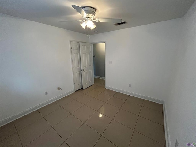 3404 Veronica Dr, Chalmette, LA 70043 - empty room with light tile patterned floors, a ceiling fan, and baseboards