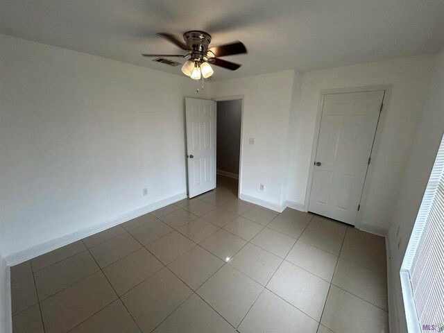 3404 Veronica Dr, Chalmette, LA 70043 - unfurnished bedroom featuring tile patterned floors, baseboards, and a ceiling fan