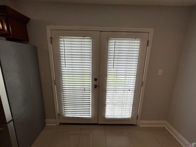 3404 Veronica Dr, Chalmette, LA 70043 - doorway to outside with french doors, light tile patterned floors, and baseboards