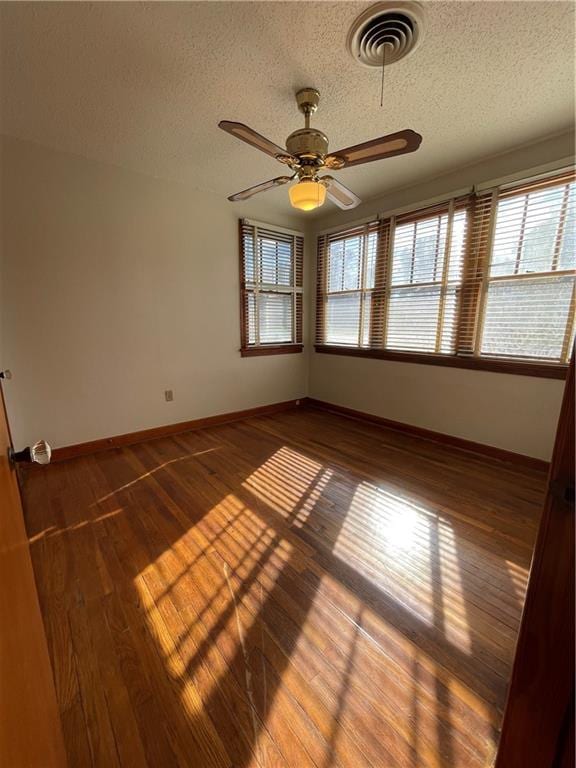 65 Willow Dr, Gretna, LA 70053 - unfurnished room with a ceiling fan, a textured ceiling, wood-type flooring, baseboards, and visible vents