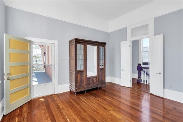 foyer featuring baseboards and wood finished floors