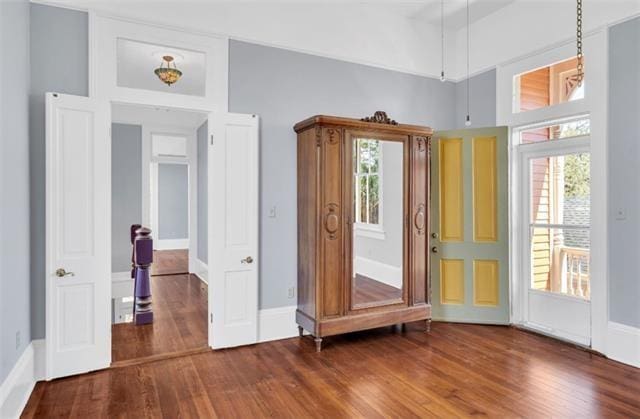 interior space featuring baseboards and wood finished floors
