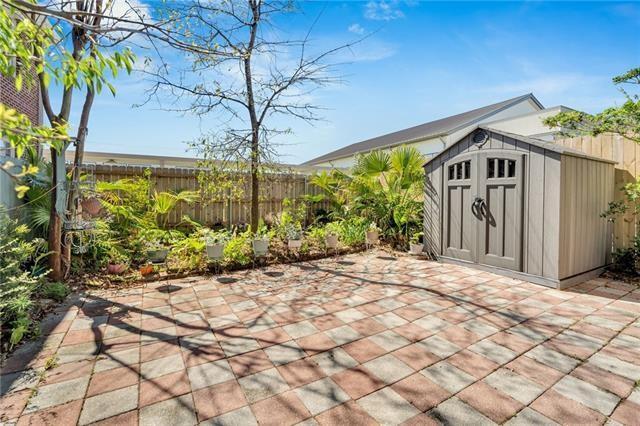 view of patio featuring an outbuilding, a storage unit, and a fenced backyard