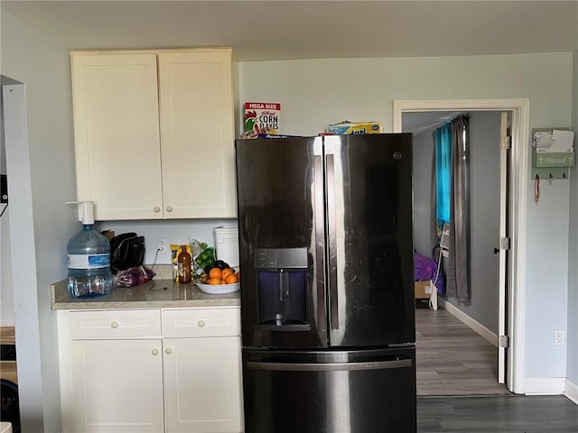 209 10th St, Bridge City, LA 70094 - kitchen with white cabinets, baseboards, dark wood-style floors, and fridge with ice dispenser