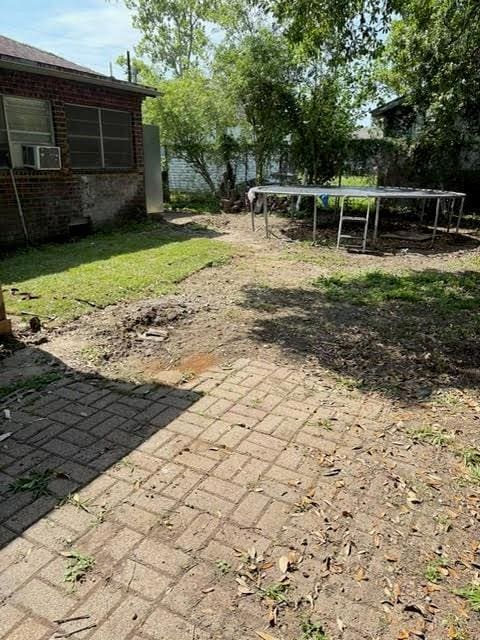 209 10th St, Bridge City, LA 70094 - view of yard with fence, a patio area, cooling unit, and a trampoline