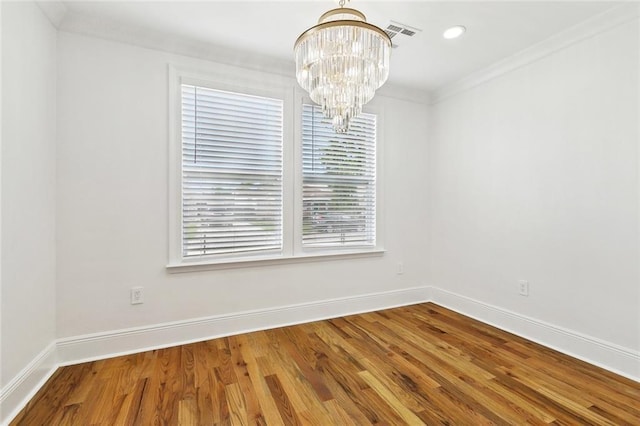 3839 Johnson St, Metairie, LA 70001 - unfurnished dining area featuring a chandelier, baseboards, healthy amount of natural light, wood finished floors, and crown molding