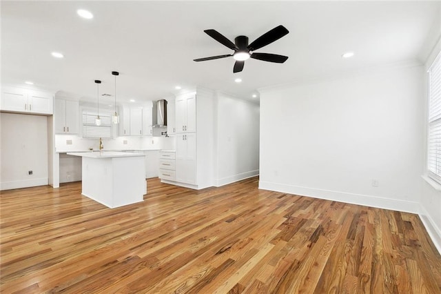3839 Johnson St, Metairie, LA 70001 - unfurnished living room featuring recessed lighting, light wood-style floors, a ceiling fan, baseboards, and ornamental molding