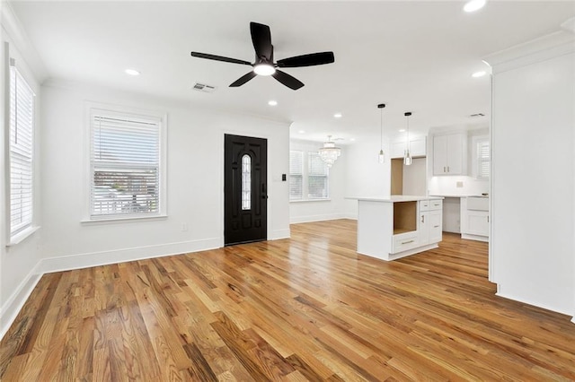 3839 Johnson St, Metairie, LA 70001 - unfurnished living room with a ceiling fan, light wood-style floors, a chandelier, baseboards, and recessed lighting