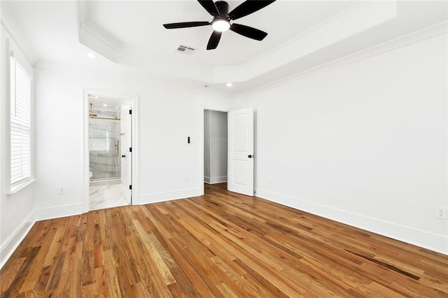 3839 Johnson St, Metairie, LA 70001 - unfurnished bedroom with ornamental molding, a tray ceiling, wood finished floors, recessed lighting, and baseboards