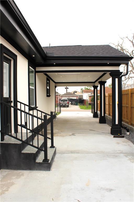3839 Johnson St, Metairie, LA 70001 - view of patio with fence, concrete driveway, and an attached carport