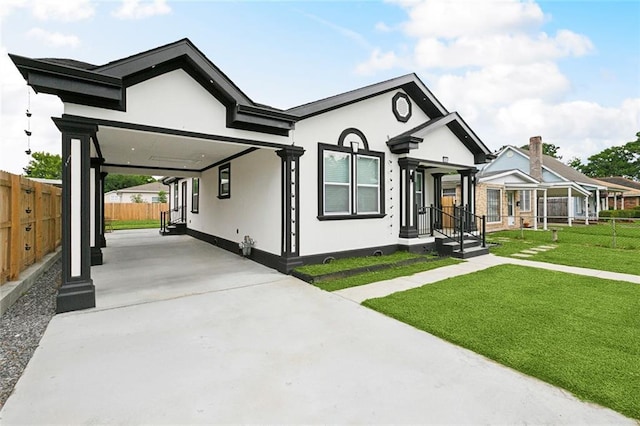 3839 Johnson St, Metairie, LA 70001 - view of front facade with an attached carport, stucco siding, and concrete driveway