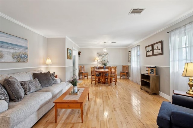 972 Tavel Dr, Kenner, LA 70065 - living area with ornamental molding, baseboards, a chandelier, light wood finished floors, and visible vents