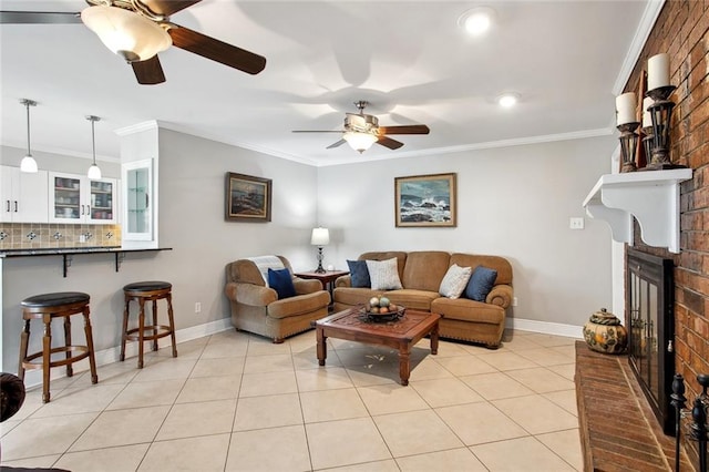 972 Tavel Dr, Kenner, LA 70065 - living room featuring crown molding, a brick fireplace, light tile patterned floors, baseboards, and ceiling fan