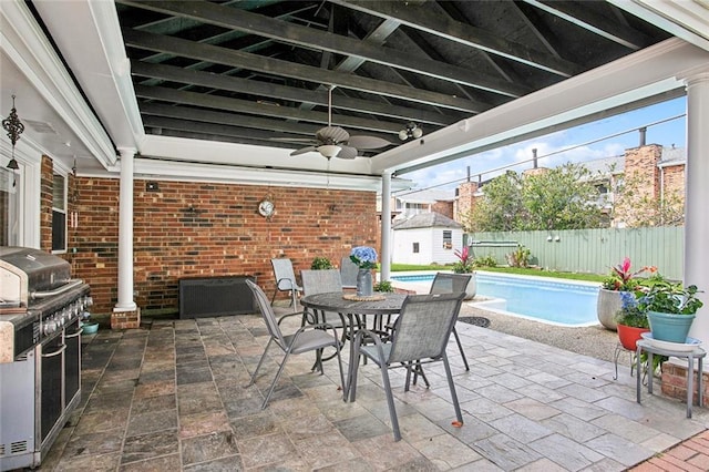 972 Tavel Dr, Kenner, LA 70065 - view of patio / terrace with ceiling fan, a fenced backyard, outdoor dining space, a fenced in pool, and an outdoor structure