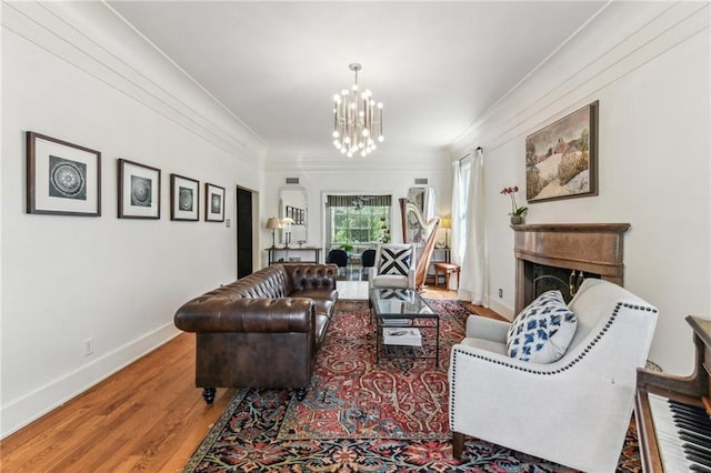 4209 Vendome Pl, New Orleans, LA 70125 - living area with crown molding, baseboards, wood finished floors, and a notable chandelier