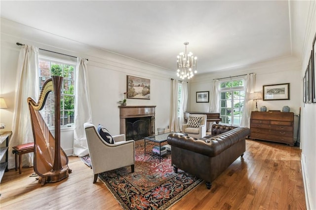 4209 Vendome Pl, New Orleans, LA 70125 - living room featuring a notable chandelier, light wood-type flooring, and plenty of natural light