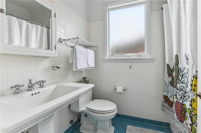 4209 Vendome Pl, New Orleans, LA 70125 - bathroom with tile walls, toilet, tile patterned floors, a shower with curtain, and a sink