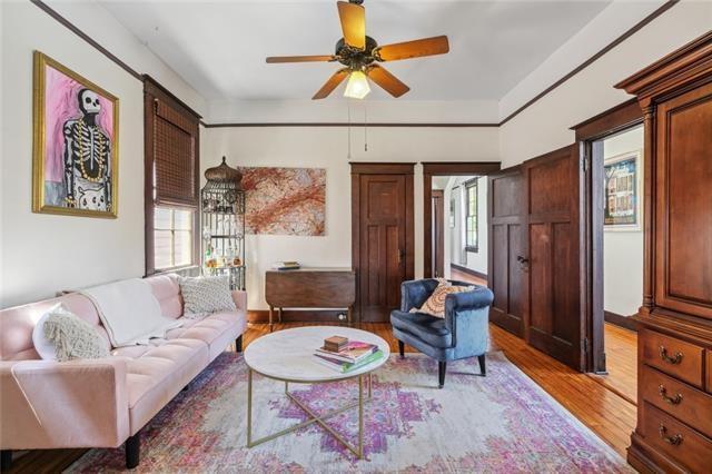 living area with light wood-type flooring and a ceiling fan