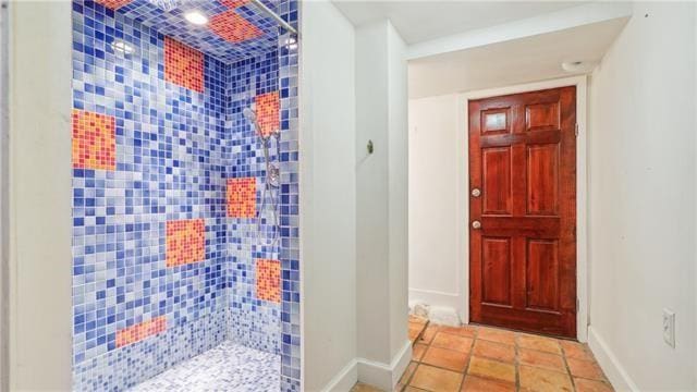 interior space featuring baseboards, tile patterned flooring, and tiled shower
