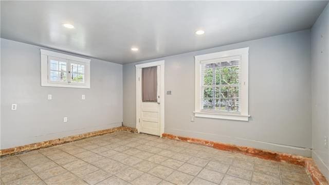 spare room with baseboards and recessed lighting