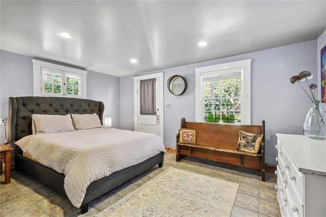 bedroom with light tile patterned flooring and recessed lighting