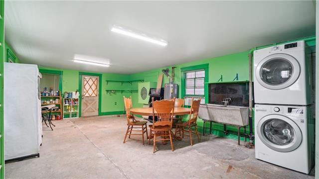laundry room featuring stacked washer and dryer, laundry area, and a sink
