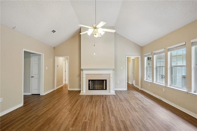 441 Parlange Dr, Pearl River, LA 70452 - unfurnished living room featuring a ceiling fan, a fireplace with flush hearth, wood finished floors, high vaulted ceiling, and a textured ceiling