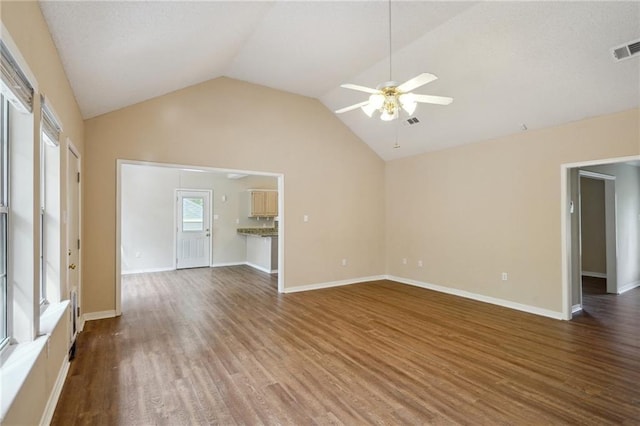 441 Parlange Dr, Pearl River, LA 70452 - unfurnished living room with a ceiling fan, wood finished floors, vaulted ceiling, and baseboards