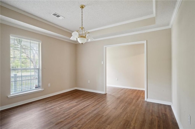441 Parlange Dr, Pearl River, LA 70452 - spare room featuring healthy amount of natural light, a chandelier, wood finished floors, a raised ceiling, and a textured ceiling