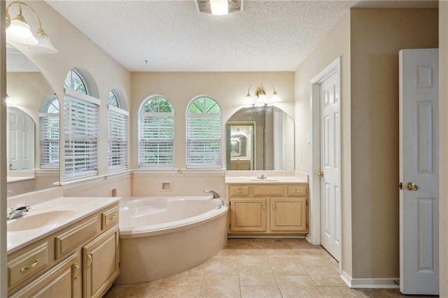 441 Parlange Dr, Pearl River, LA 70452 - full bath featuring two vanities, a bath, tile patterned floors, and a textured ceiling
