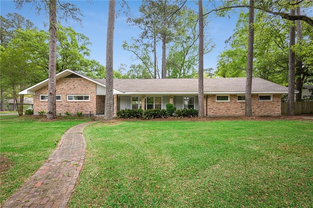 119 Belle Terre Blvd, Covington, LA 70433 - view of front of house featuring brick siding and a front lawn
