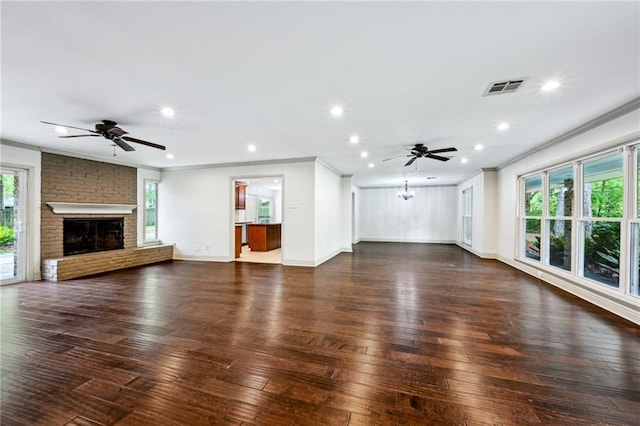 119 Belle Terre Blvd, Covington, LA 70433 - unfurnished living room with a brick fireplace, dark wood-style flooring, crown molding, and ceiling fan
