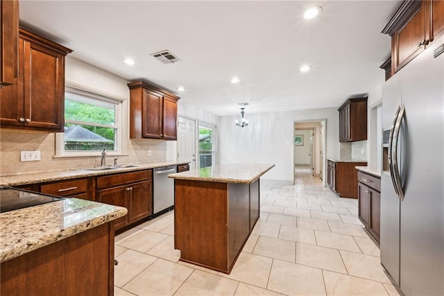 119 Belle Terre Blvd, Covington, LA 70433 - kitchen with visible vents, appliances with stainless steel finishes, a sink, an inviting chandelier, and a center island