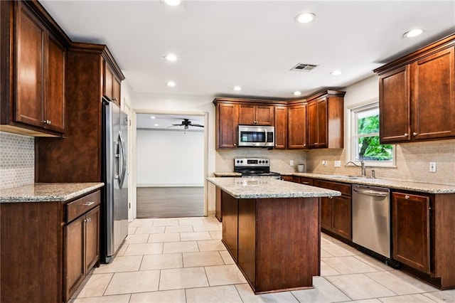 119 Belle Terre Blvd, Covington, LA 70433 - kitchen featuring visible vents, stainless steel appliances, a sink, a center island, and light tile patterned floors