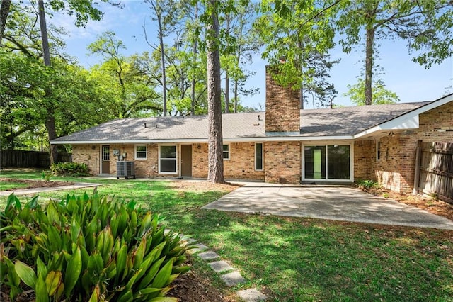 119 Belle Terre Blvd, Covington, LA 70433 - rear view of property featuring a chimney, a lawn, fence, and a patio