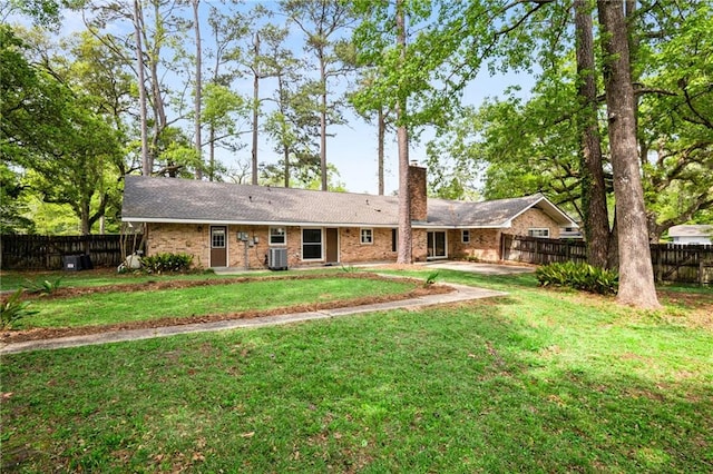 119 Belle Terre Blvd, Covington, LA 70433 - ranch-style house featuring a chimney, brick siding, fence, and a front lawn