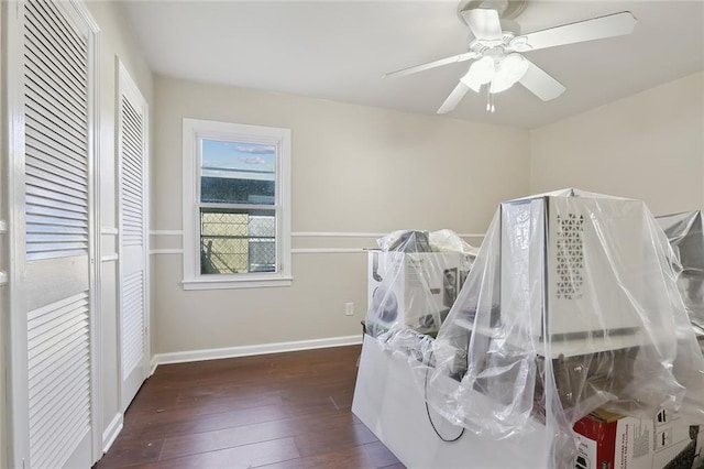 interior space featuring baseboards, ceiling fan, and wood-type flooring