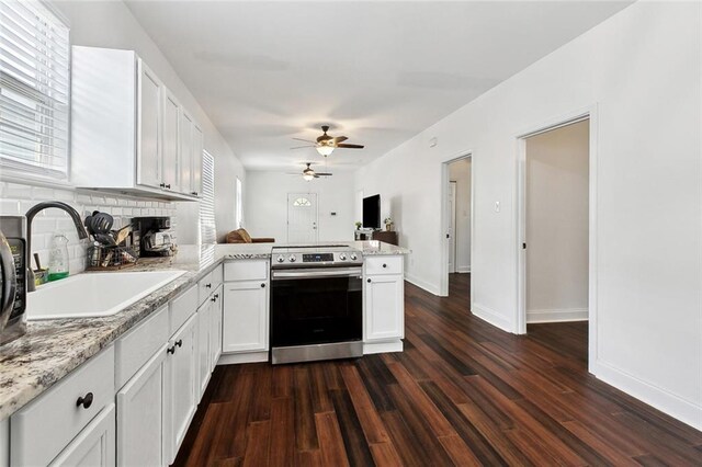 3239 Bloomingdale Ct, New Orleans, LA 70125 - kitchen featuring stainless steel range with electric stovetop, a sink, a peninsula, ceiling fan, and white cabinets